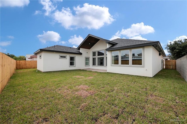 2427 Summer Breeze St, Mission, TX 78572 - rear view of property featuring stucco siding, a fenced backyard, and roof with shingles