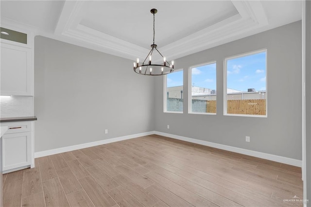 2427 Summer Breeze St, Mission, TX 78572 - unfurnished dining area featuring a chandelier, a raised ceiling, and light wood-style floors