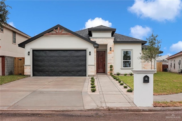 2427 Summer Breeze St, Mission, TX 78572 - view of front facade with stone siding, a garage, stucco siding, and concrete driveway