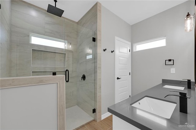 2427 Summer Breeze St, Mission, TX 78572 - full bathroom featuring double vanity, a stall shower, and wood finished floors