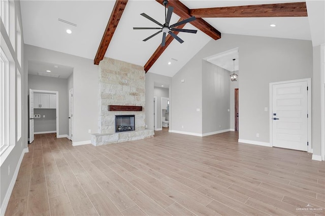 2427 Summer Breeze St, Mission, TX 78572 - unfurnished living room with a ceiling fan, beam ceiling, high vaulted ceiling, light wood-style flooring, and a fireplace