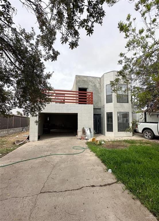 7300 Ciruelos St, Palmview, TX 78572 - view of front of property with an attached garage, driveway, and a balcony
