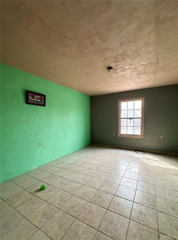 unfurnished room featuring light tile patterned floors