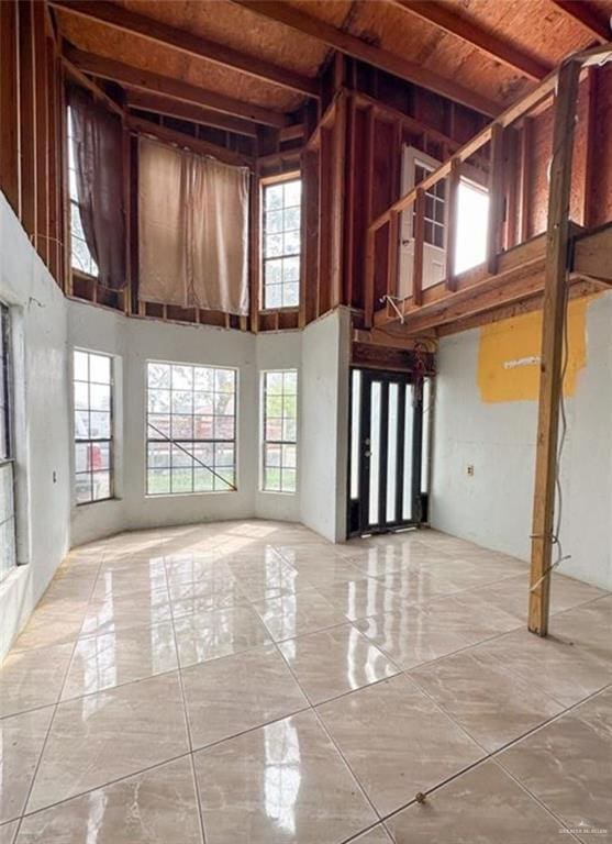 7300 Ciruelos St, Palmview, TX 78572 - unfurnished living room featuring a high ceiling, marble tiled flooring, and wood ceiling