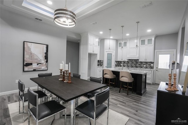 3005 E Q Ave, Hidalgo, TX 78557 - dining room with recessed lighting, light wood-type flooring, and a tray ceiling