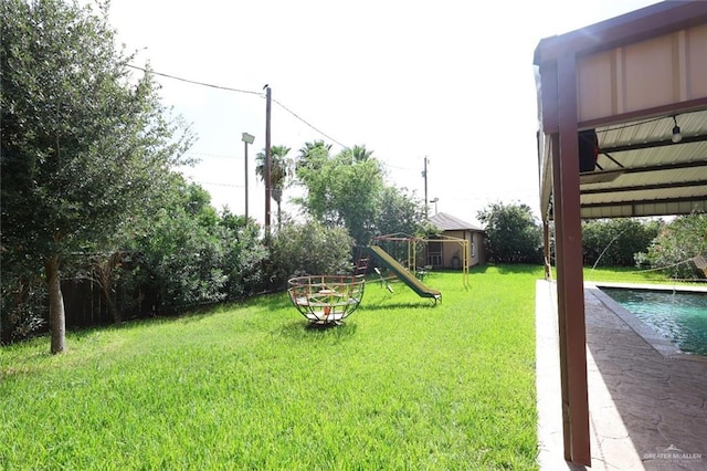 5310 Nicole Dr, Edinburg, TX 78542 - view of grassy yard featuring an outdoor pool and a playground