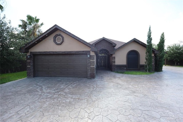 5310 Nicole Dr, Edinburg, TX 78542 - view of front facade featuring stucco siding, driveway, and an attached garage