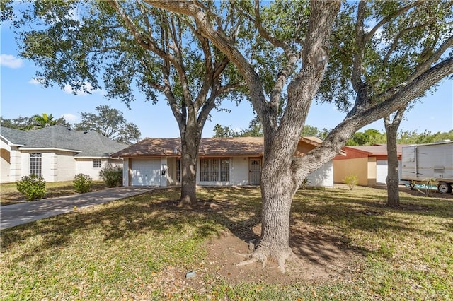 ranch-style home with a garage and a front yard