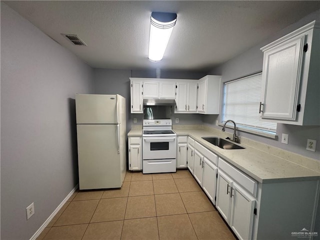 914 Denver St, Edinburg, TX 78541 - kitchen with white appliances, under cabinet range hood, white cabinetry, light countertops, and a textured ceiling