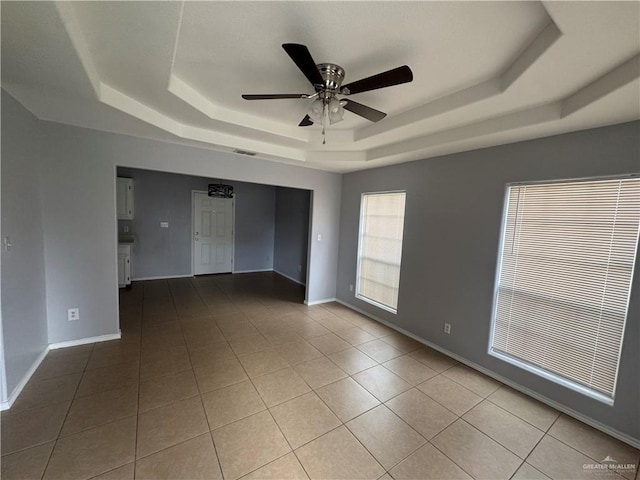 914 Denver St, Edinburg, TX 78541 - empty room featuring a tray ceiling, ceiling fan, and tile patterned floors