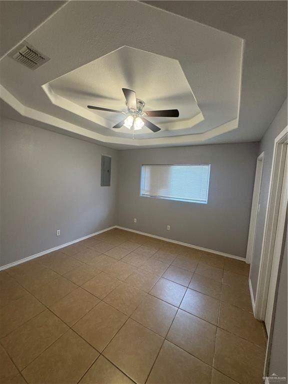 914 Denver St, Edinburg, TX 78541 - spare room with a tray ceiling, tile patterned flooring, ceiling fan, and electric panel