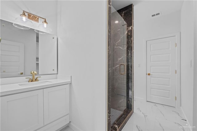 bathroom featuring vanity and an enclosed shower