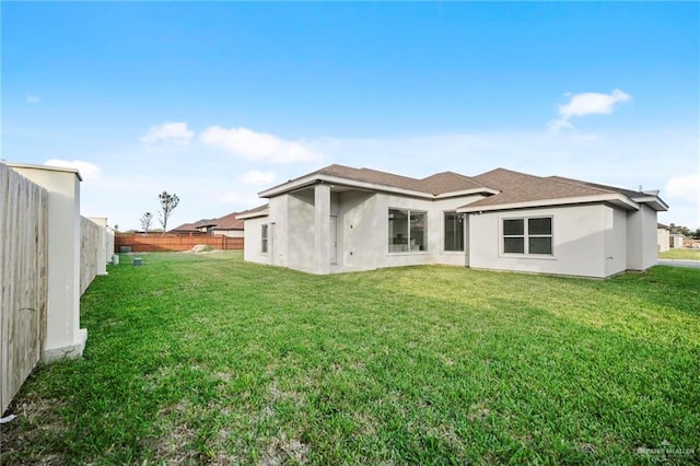 rear view of house with a lawn