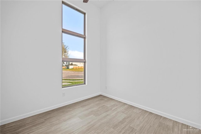 spare room with light hardwood / wood-style flooring