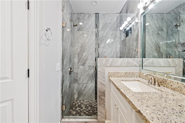 bathroom with vanity and an enclosed shower