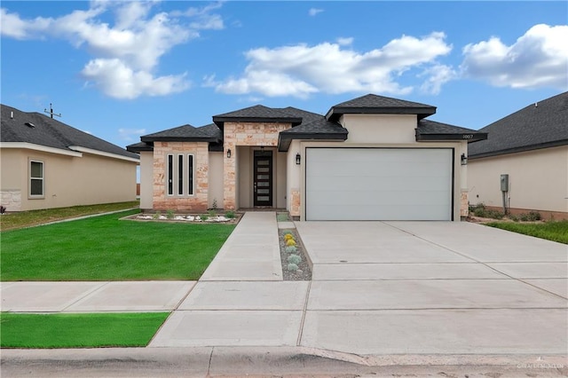 prairie-style house featuring a front yard and a garage