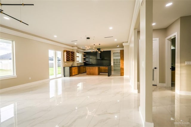 kitchen with crown molding, sink, and pendant lighting