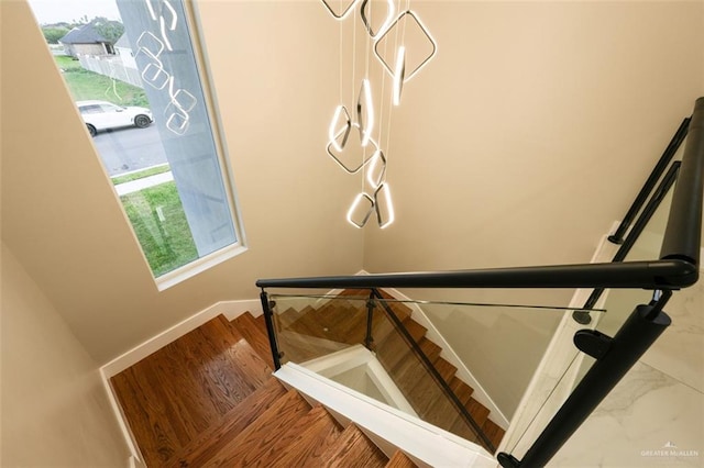 stairs with hardwood / wood-style flooring