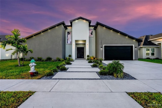 view of front facade with a lawn and a garage