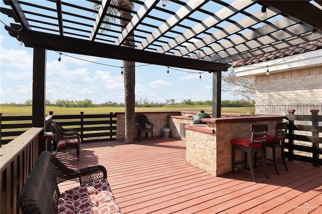 wooden terrace with a rural view, outdoor dry bar, and a pergola