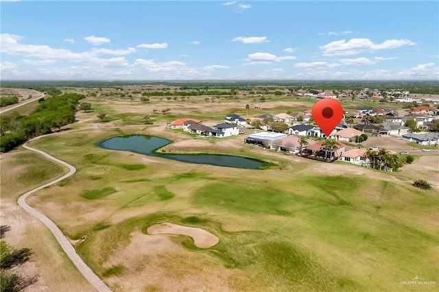 drone / aerial view with a residential view, a water view, and golf course view