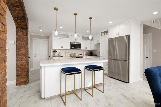 kitchen featuring marble finish floor, white cabinets, stainless steel appliances, and glass insert cabinets