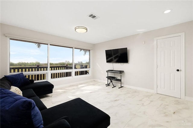 living room featuring visible vents, marble finish floor, and baseboards