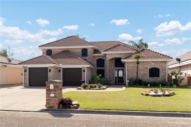 mediterranean / spanish-style home with a front lawn, a tiled roof, an attached garage, and concrete driveway