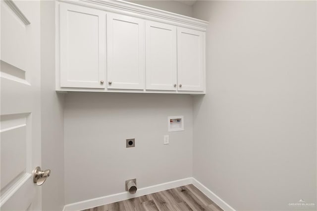 laundry room with hookup for an electric dryer, hookup for a washing machine, baseboards, light wood-style flooring, and cabinet space