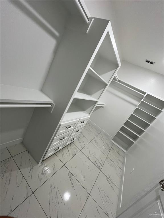 411 Thornwood Loop, Rio Grande City, TX 78582 - walk in closet featuring marble look tiles