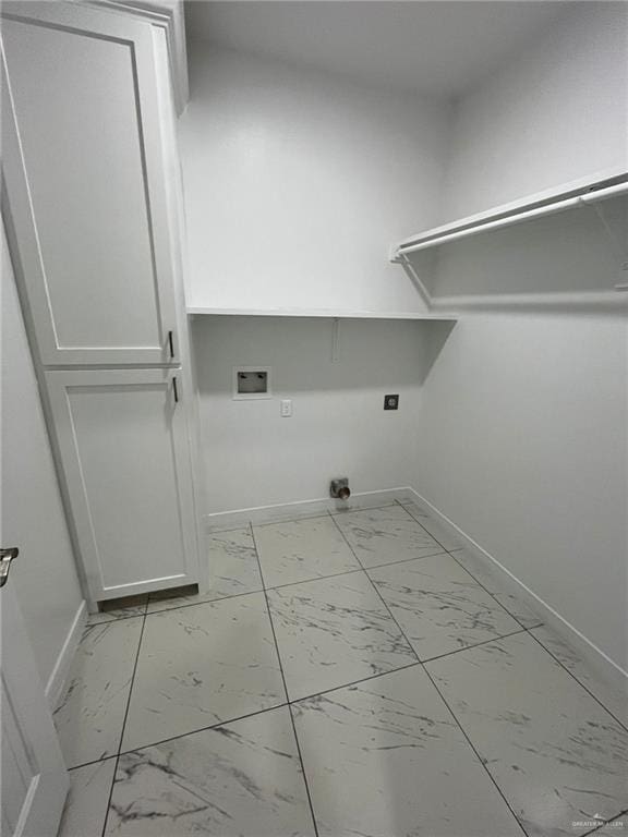 411 Thornwood Loop, Rio Grande City, TX 78582 - washroom featuring baseboards, washer hookup, and light marble finish flooring