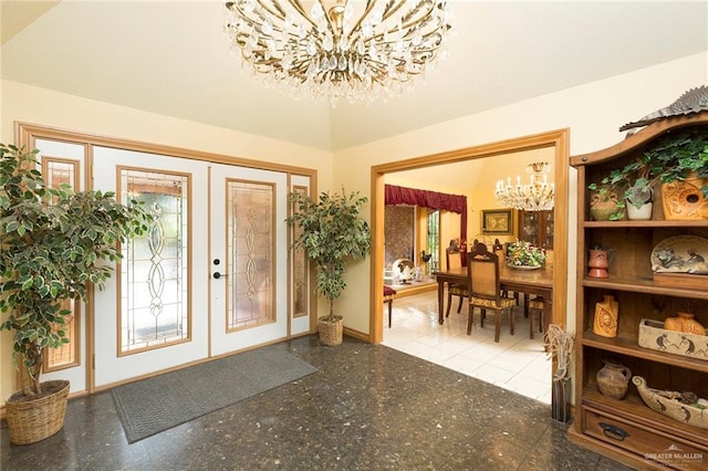 foyer entrance with french doors and a notable chandelier