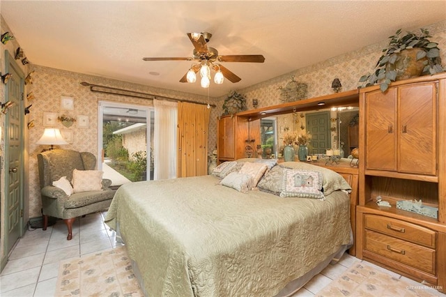 tiled bedroom featuring ceiling fan and access to outside