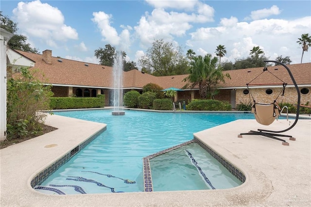 view of swimming pool with pool water feature