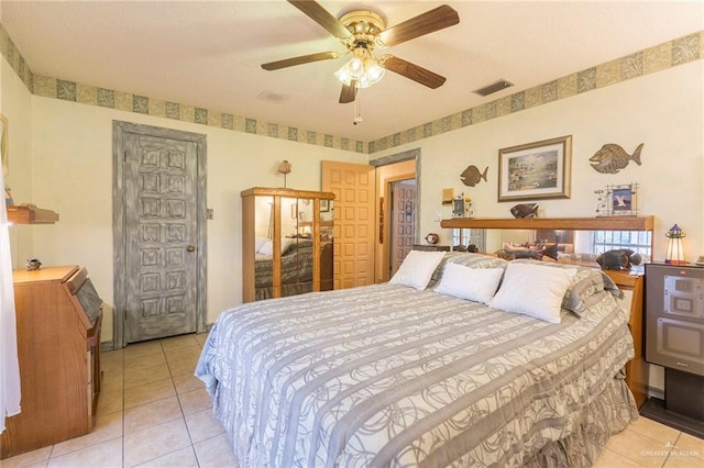 tiled bedroom featuring ceiling fan