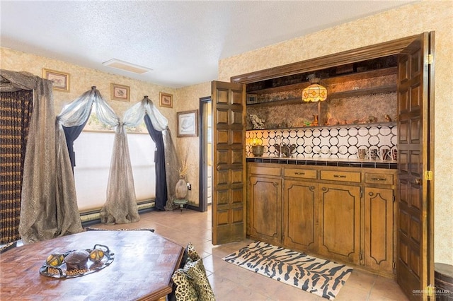 tiled bedroom with a textured ceiling and a large fireplace