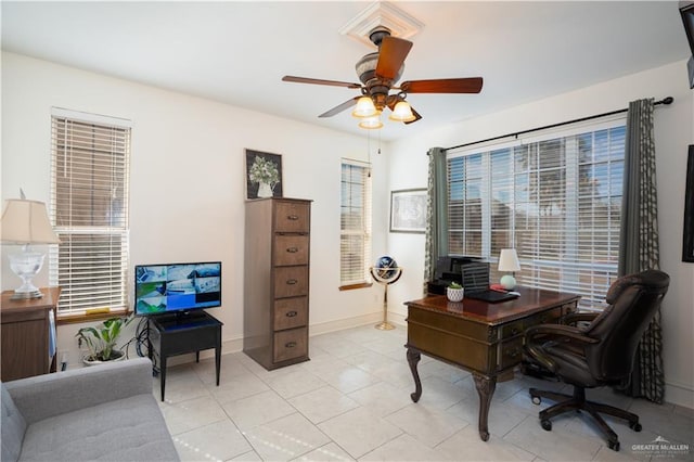 tiled office space featuring ceiling fan