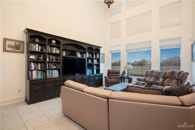 tiled living room featuring a towering ceiling