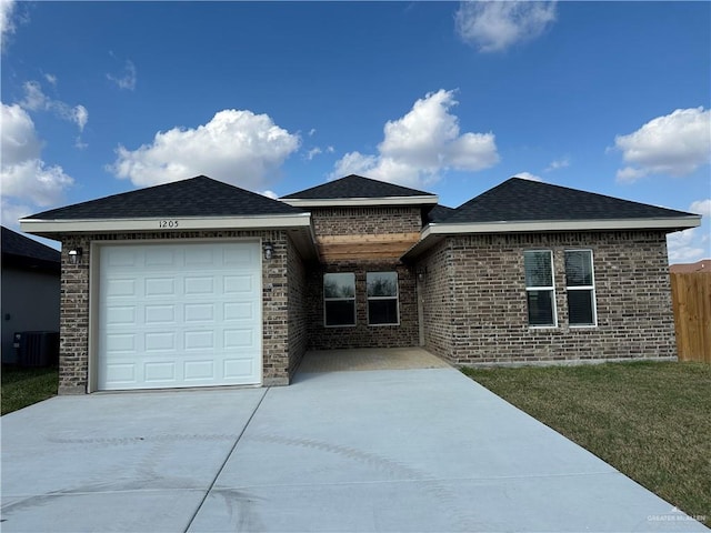 single story home featuring a garage, central AC unit, and a front lawn