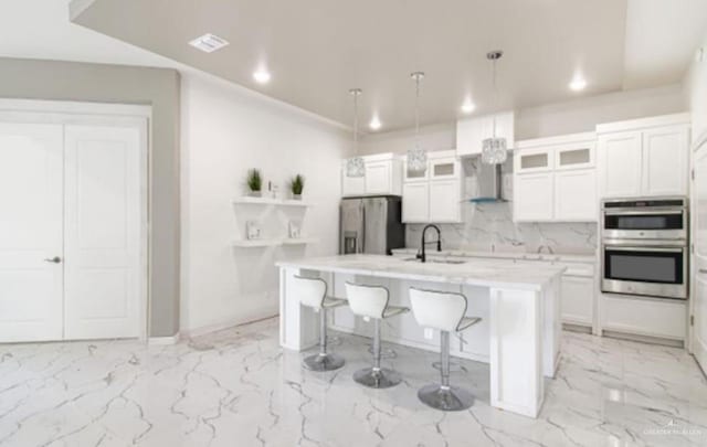 3011 E Ebano Ave, Hidalgo, TX 78557 - kitchen featuring recessed lighting, light countertops, stainless steel appliances, a kitchen island with sink, and a breakfast bar