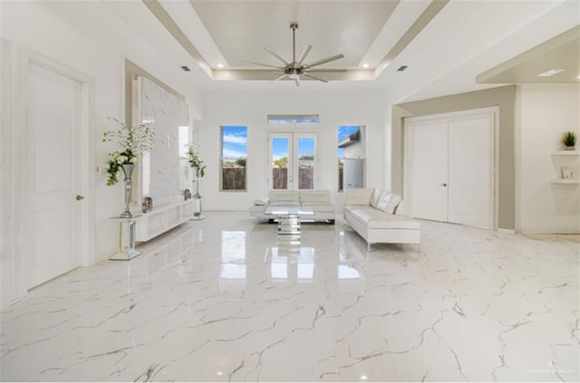 3011 E Ebano Ave, Hidalgo, TX 78557 - living area with a tray ceiling, french doors, a ceiling fan, and marble tiled flooring