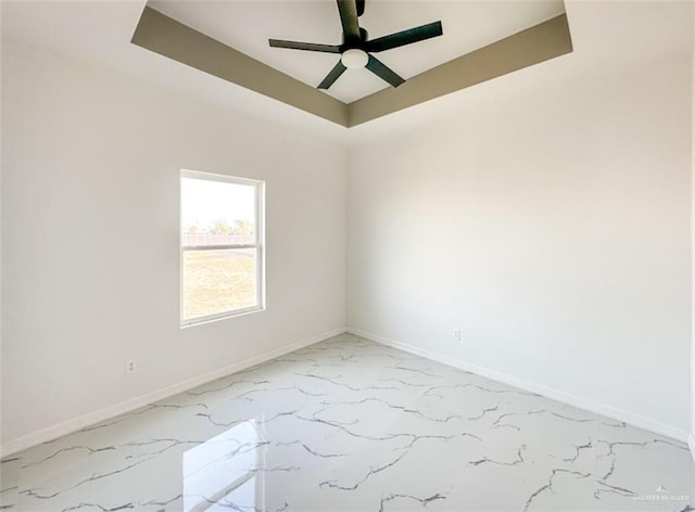 3011 E Ebano Ave, Hidalgo, TX 78557 - spare room featuring light marble finish flooring, ceiling fan, and a raised ceiling