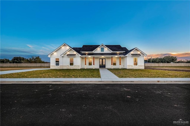 modern farmhouse featuring a lawn