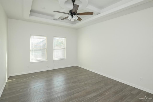 unfurnished room with ceiling fan, dark wood-type flooring, coffered ceiling, and baseboards