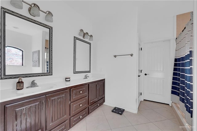 full bathroom with a sink, double vanity, and tile patterned flooring