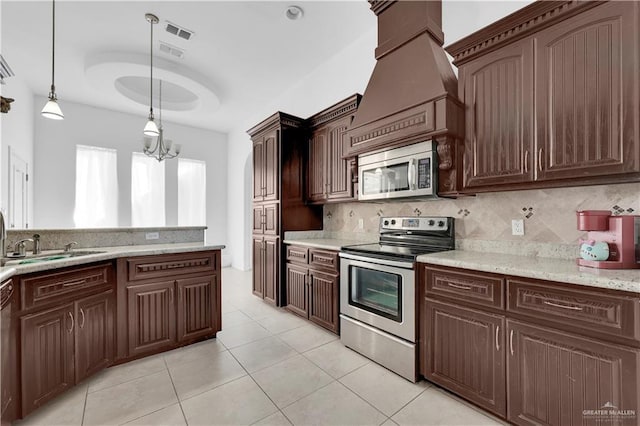 kitchen with decorative backsplash, dark brown cabinets, visible vents, and stainless steel appliances