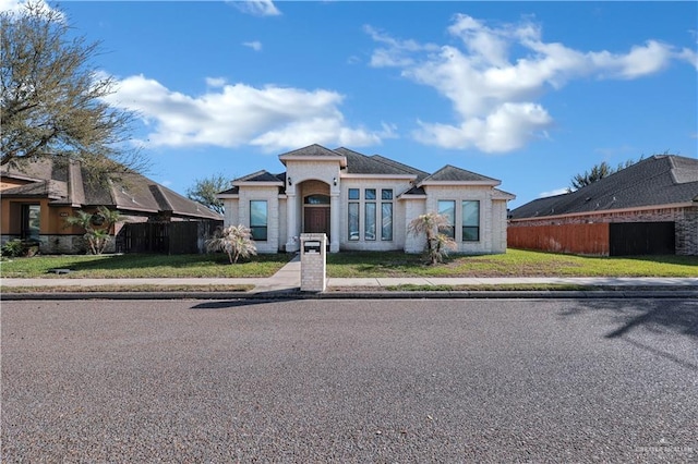 view of front facade with a front yard and fence