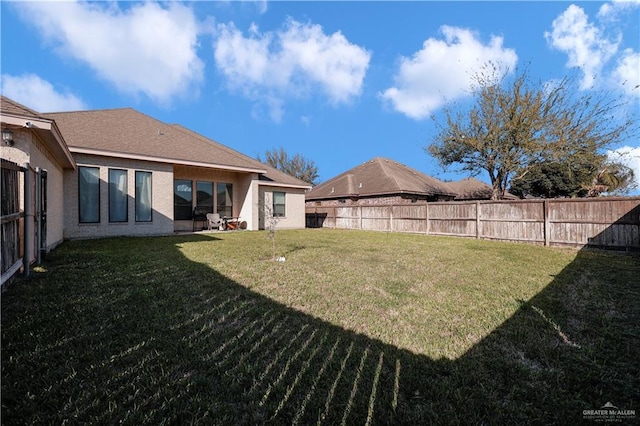 view of yard with a fenced backyard