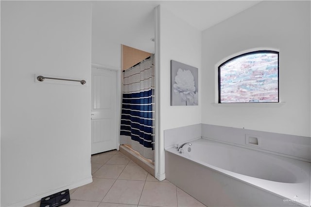 full bath with tile patterned floors and a bath