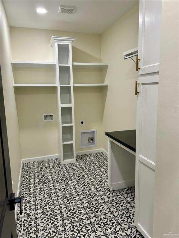washroom with hookup for an electric dryer, visible vents, baseboards, hookup for a washing machine, and laundry area